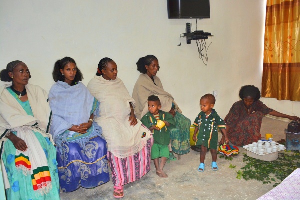 Group of pregnant women and two children sitting in a row
